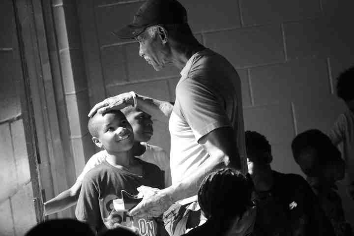 Stephen Garland, program director for the The Hardy Center, pats Deiondre Ray,10, on the head while he walks out of the auditorium in the Linden neighborhood of Columbus. The Center was created by Garland in partnership when the previous inhabitants, a local church, wanted to dedicate their building to a good cause. Garland worked with the group to convert the structure into a space for local kids.   (Brooke LaValley / The Columbus Dispatch)